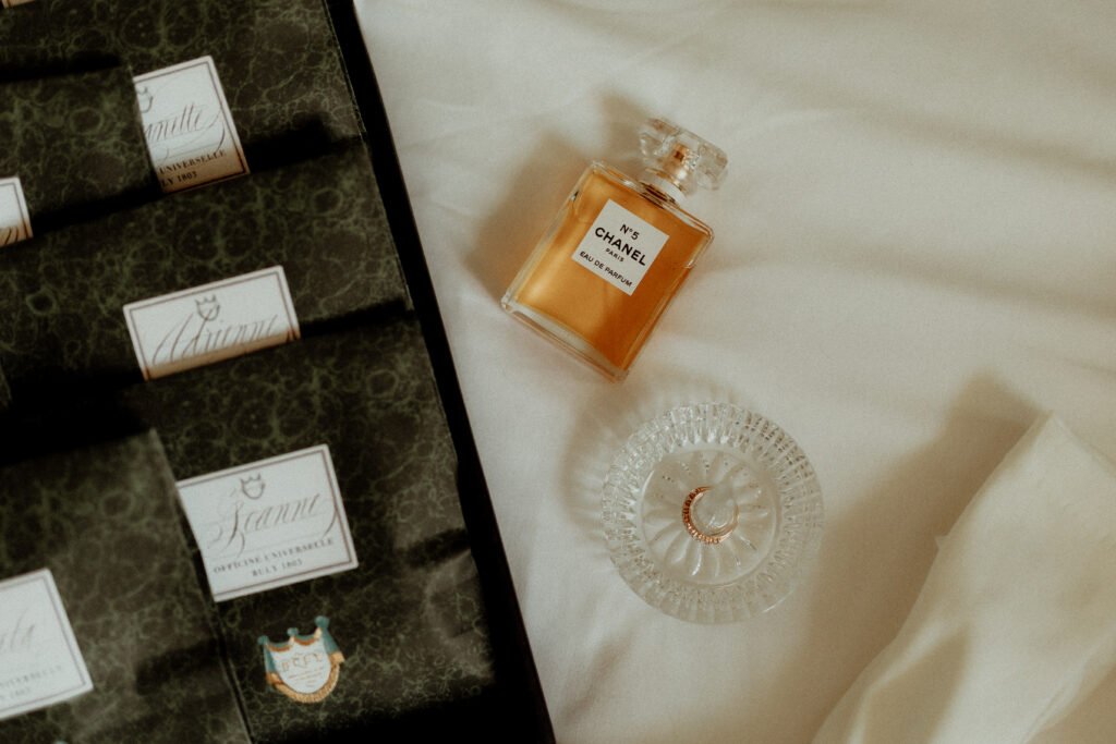 a perfume bottle and a ring on a table