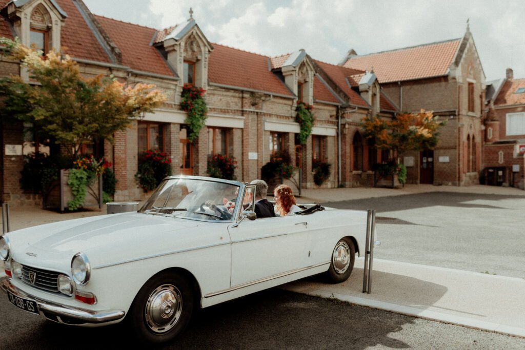a couple in a convertible car
